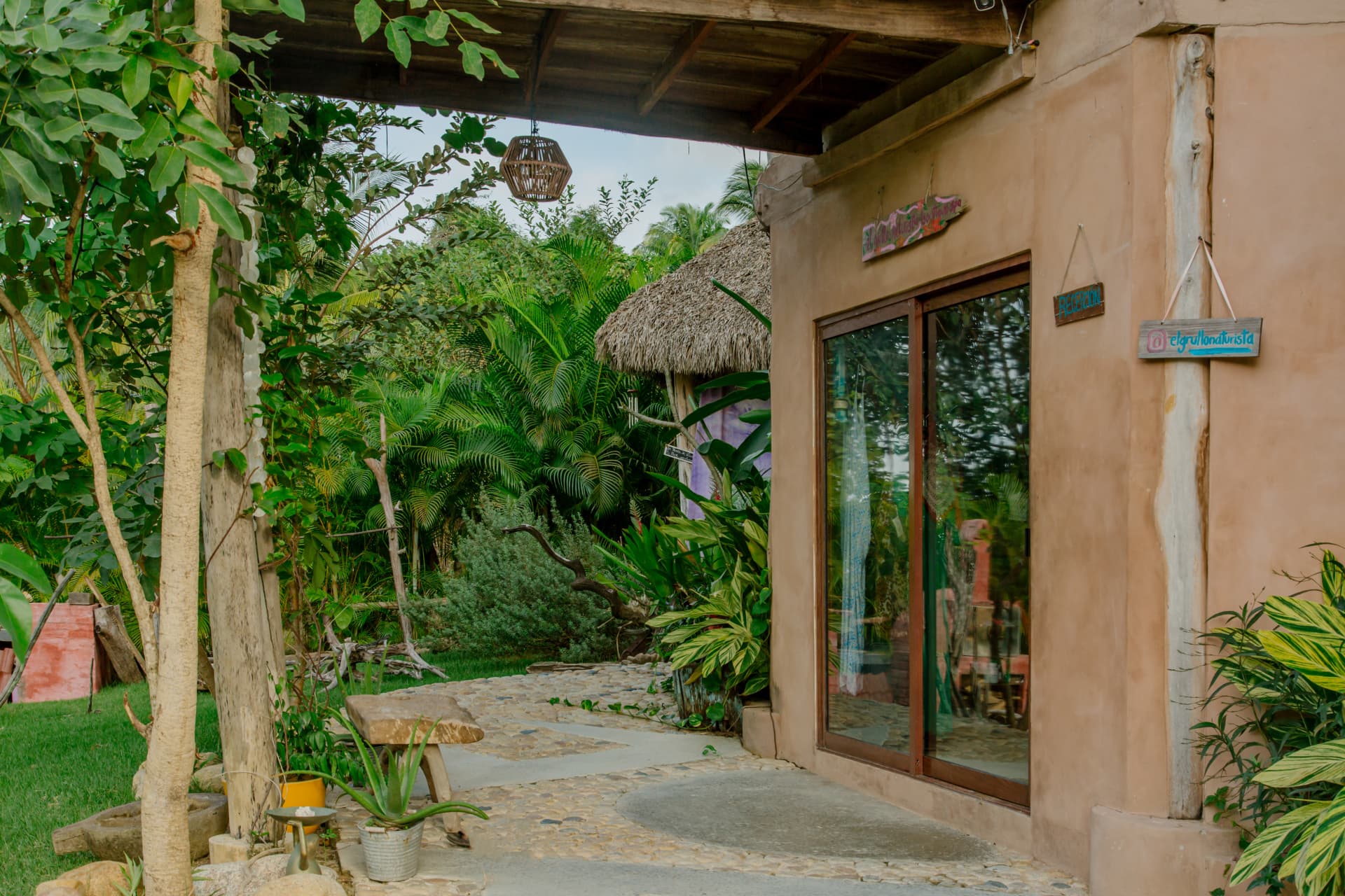 Hotel reception among the greenery with hand-painted signs