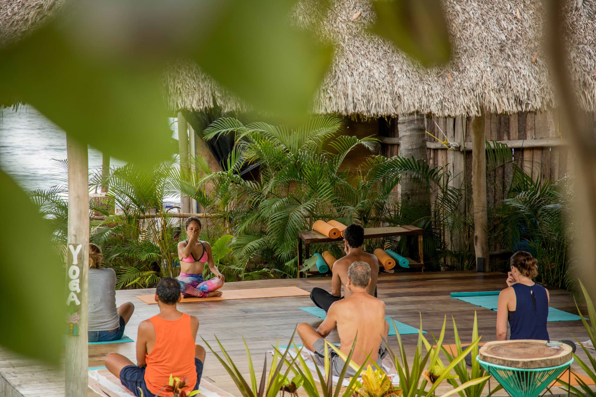 Group yoga class on the Xala deck facing the ocean