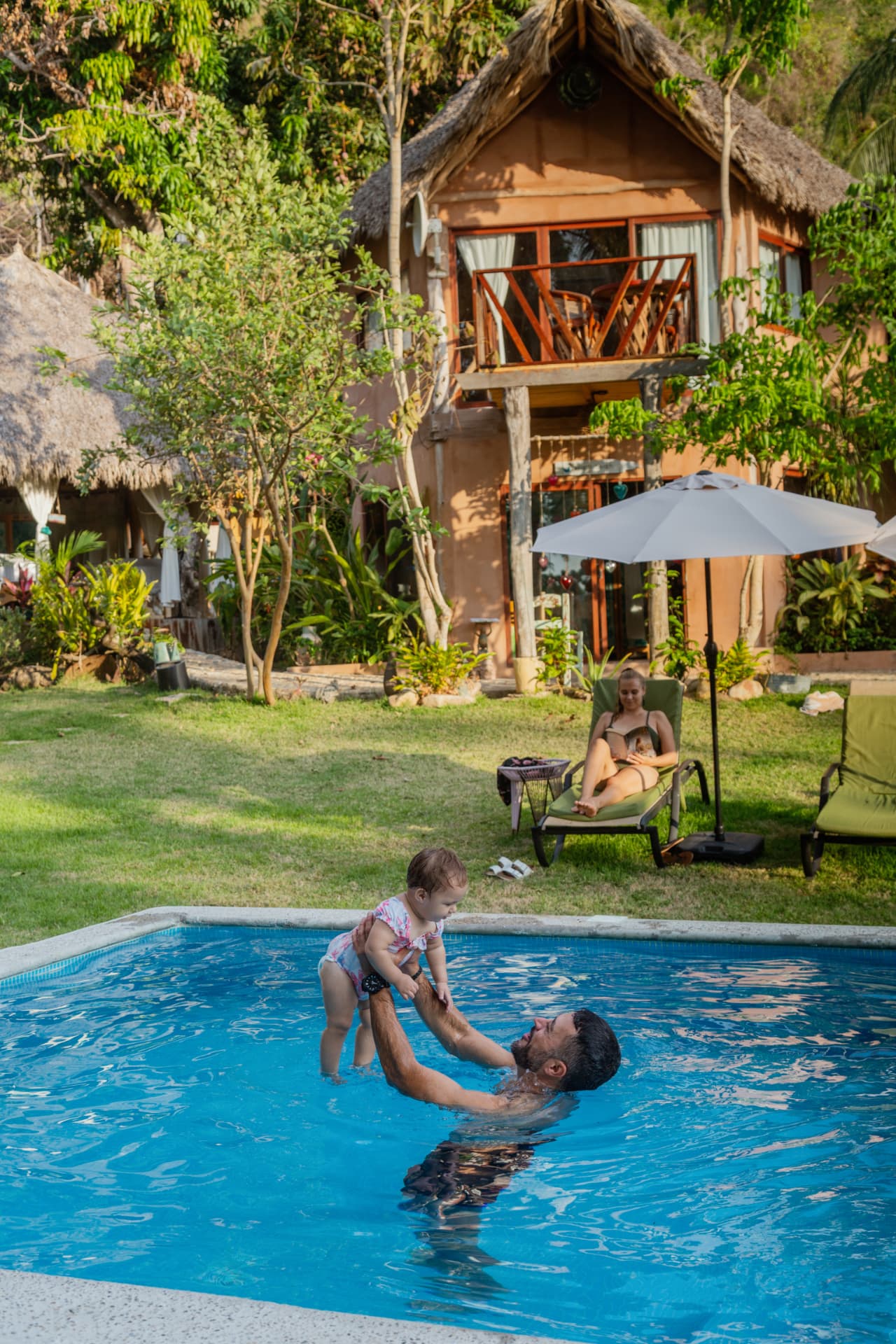 Dad and baby playing in the hotel pool