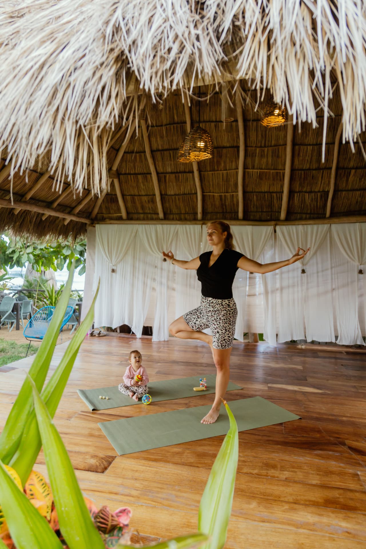 Yoga practice at sunrise by the sea in Quimixto