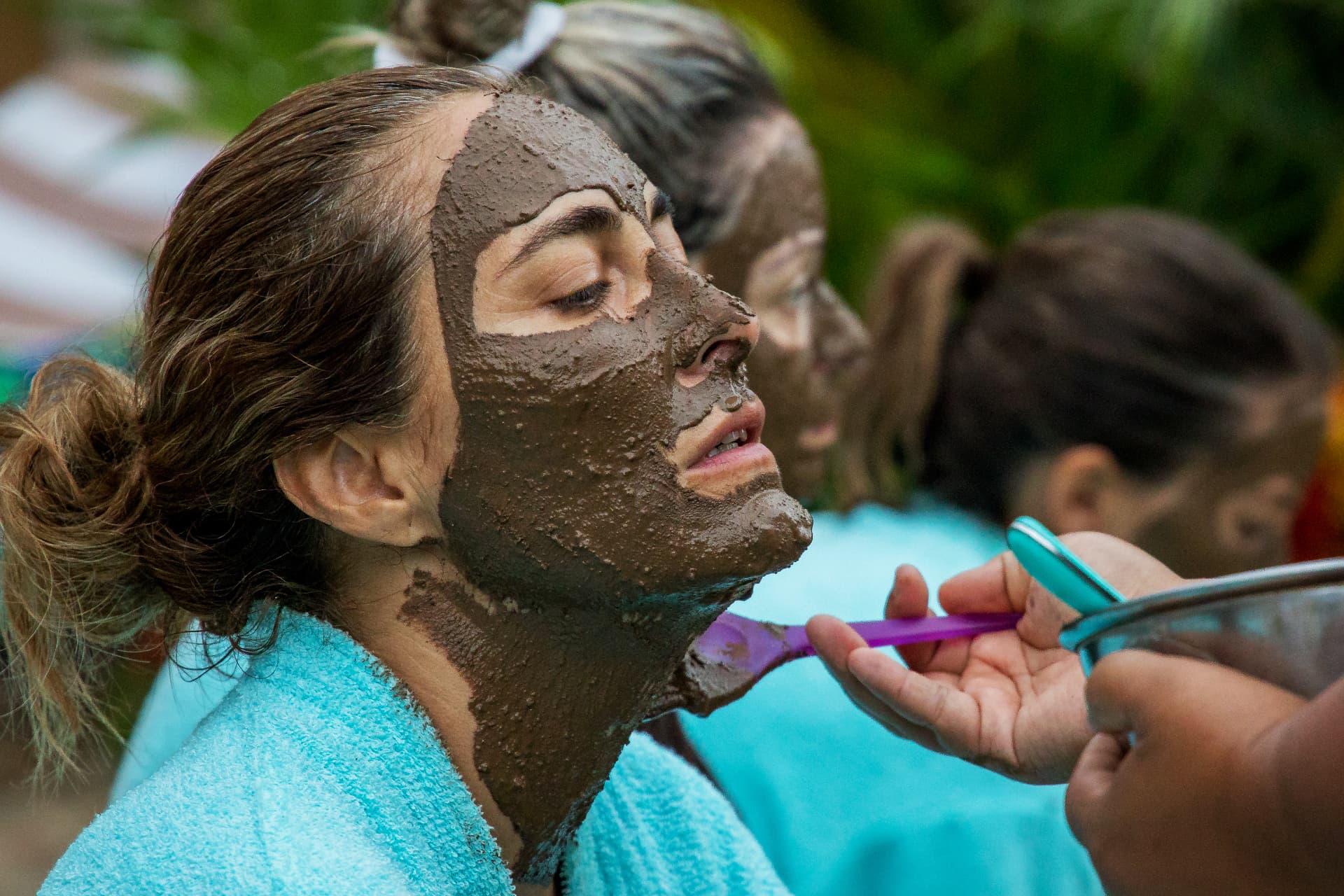 Clay mask brushed on in the garden