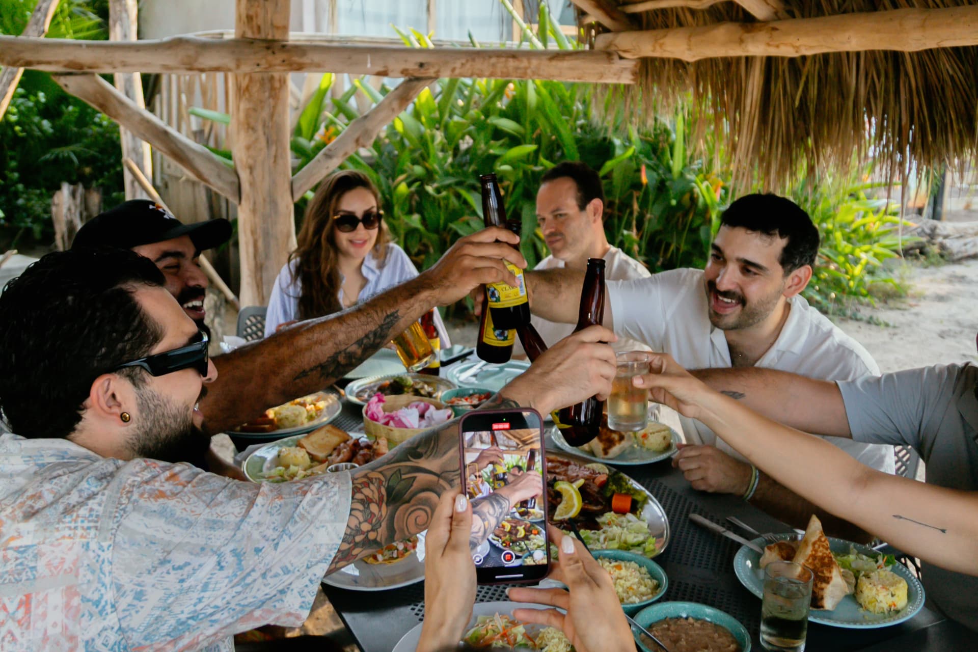 Close-up of a toast with cold beers by the sea
